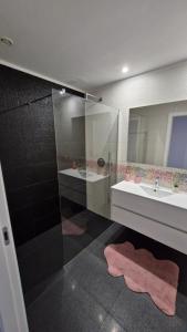 a bathroom with two sinks and a glass shower at Appartement Ponte de lima in Ponte de Lima +18 photos