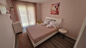 a small bedroom with a bed with two pillows at Appartement Ponte de lima in Ponte de Lima