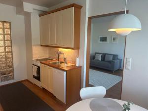 a kitchen with a sink and a living room at Finngland I in Rovaniemi