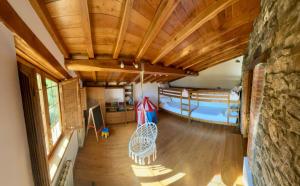 a room with wooden ceilings and a room with a pool at La Fontina de Tene in Tene