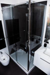 a bathroom with a shower and a toilet and a sink at PgrHome Luxury Apartments Parione in Rome