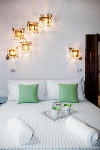 a bed with a tray with two cups on it at PgrHome Luxury Apartments Parione in Rome