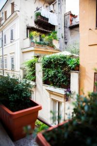 a building with potted plants on the side of it at PgrHome Luxury Apartments Parione in Rome