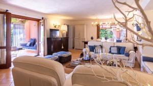 a living room with two couches and a table at VILLA BAMBU' 9&2, Emma Villas in Maratea