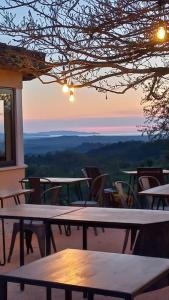 a group of tables and chairs on a patio with a view at Casa di Luca Catabbio in Catabbio