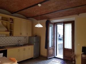 a kitchen with a refrigerator and a sliding glass door at Casa di Luca Catabbio in Catabbio