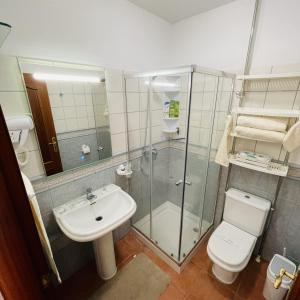 a bathroom with a shower and a toilet and a sink at Apartamento Brisas del Sur - Oasis Tenerife Sur in Playa de San Juan +32 photos