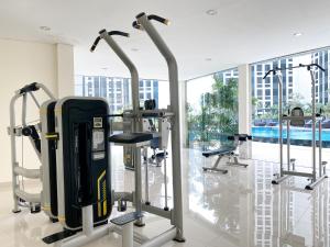 a gym with cardio equipment in a building at Cozy and Comfort 2BR at Pollux Chadstone Apartment By Travelio in Cikarang