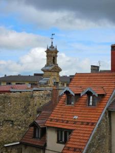 a building with a clock tower on top of it at Pontarlier Centre Historique 3ème - Ma Petite Résa in Pontarlier
