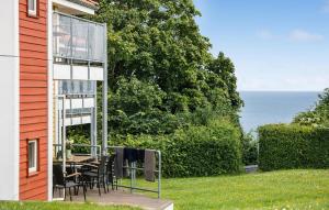a patio with a table and chairs next to a house at Gudhjem Søpark Lejl 33 in Gudhjem +15 photos
