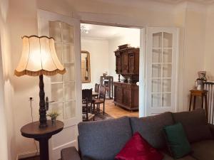 a living room with a couch and a lamp at LA MARIEFACTURE - Comme chez le Baron in Saint-Avold +39 photos