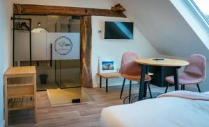 a room with a bed and a table and chairs at Bij Boon in Peize