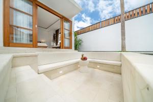 a bathroom with white walls and a large window at Stunning 2BDR Villa with Private Pool in CANGGU in Canggu
