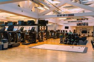 een sportschool met halters en gewichten op een houten vloer bij Hilton Warsaw City Hotel in Warschau
