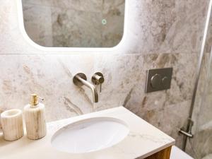 a bathroom with a sink and a mirror at FLH Boutique Studio in Warsaw