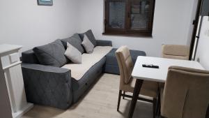 a living room with a couch and a table at Nova Panorama in Vrdnik
