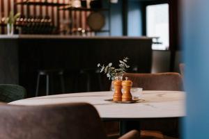 a wooden table with a vase on top of it at Hotell Alfred Nobel in Karlskoga