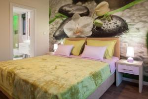 a bedroom with a bed with a flower mural on the wall at Villa Ribica in Veliko Brdo +12 photos