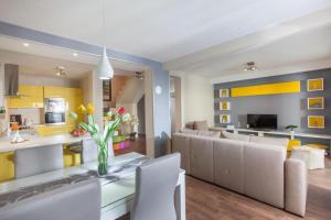 a living room with a couch and a table with a vase of flowers at Villa Ribica in Veliko Brdo