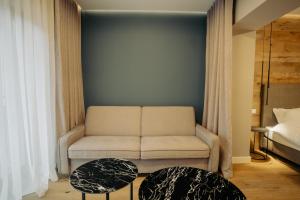 a living room with a couch and a bed at Zen Den in Braşov