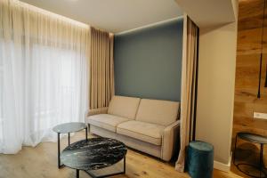 a living room with a couch and a table at Zen Den in Braşov +136 photos