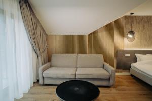 a living room with a couch and a bed at Zen Den in Braşov