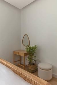 a bathroom with a toilet and a table and a mirror at Sahab - Rustic One BR Apt in Ḩiz̧āyib az Zānah