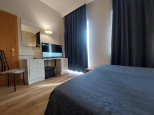 a hotel room with a bed and a flat screen tv at Eurohotel in Piacenza +52 photos