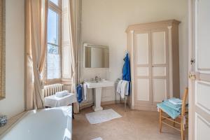 a bathroom with a bath tub and a sink at Château de famille - Dangeul - 15 personnes in Dangeul +60 photos
