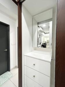 a white dresser with a mirror in a room at Homestay Rumah Kita Edusentral Setia Alam in Setia Alam