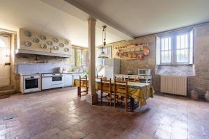 a kitchen with a table and chairs in a room at Château de famille - Dangeul - 15 personnes in Dangeul