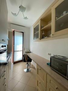 a kitchen with a counter and a chair in it at Villa Ferrari - Park Monza F1 Circuit in Villasanta