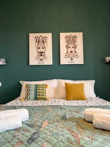 a bedroom with three pictures on the wall and a bed at VISTAMARE beach garden relax in San Leone