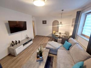 a living room with a couch and a table at Landhaus Nageler in Westendorf