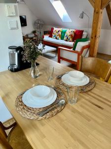 a wooden table with two plates on top of it at Apartment 23 in Český Krumlov +17 photos