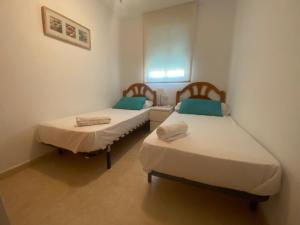 A bed or beds in a room at Delfines III Solo Familias Serviplaya