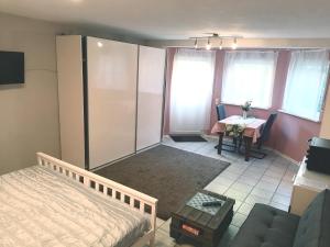a bedroom with a bed and a table and a couch at FW-Bechen in Kürten