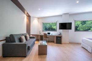 a living room with a couch and a desk at Hotel Granada by Pierre & Vacances in Granada