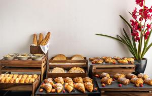 a bunch of different types of bread and pastries at The Queens Gate Hotel in London