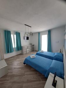 a bedroom with a blue bed and blue curtains at I Sette Ulivi Bed and Breakfast in Tergu