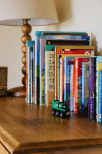 a toy truck sitting on top of books on a table at Gorgeous English Farmhouse Holiday Cottage for 9 and a half in Ellingham
