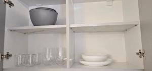 a white cabinet with a toilet and a bowl at Escape Residence in Vişeu de Sus