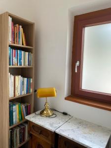 a lamp sitting on a desk next to a book shelf at Waldboden in San Leonardo in Passiria +28 photos