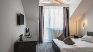 a hotel room with a bed and a window at Hotel Eden in Sibiu +63 photos
