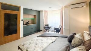 a bedroom with a bed and a table and chairs at Studio Apartman Medonis in Pasuljište