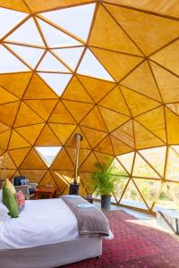 a room with a bed in a large tent at Starry Starry Night - Route 62 in Montagu
