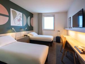 Letto o letti in una camera di ibis Styles Guéret