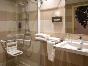 un bagno con doccia e lavandino di ibis Styles Guéret a Guéret