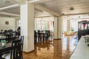 a dining room with tables and chairs in a building at Hotel Eden in Sibiu