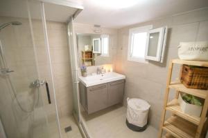 a bathroom with a shower and a sink at Kalamos sea view villa Beach walking distance in Áyioi Apóstoloi +21 photos